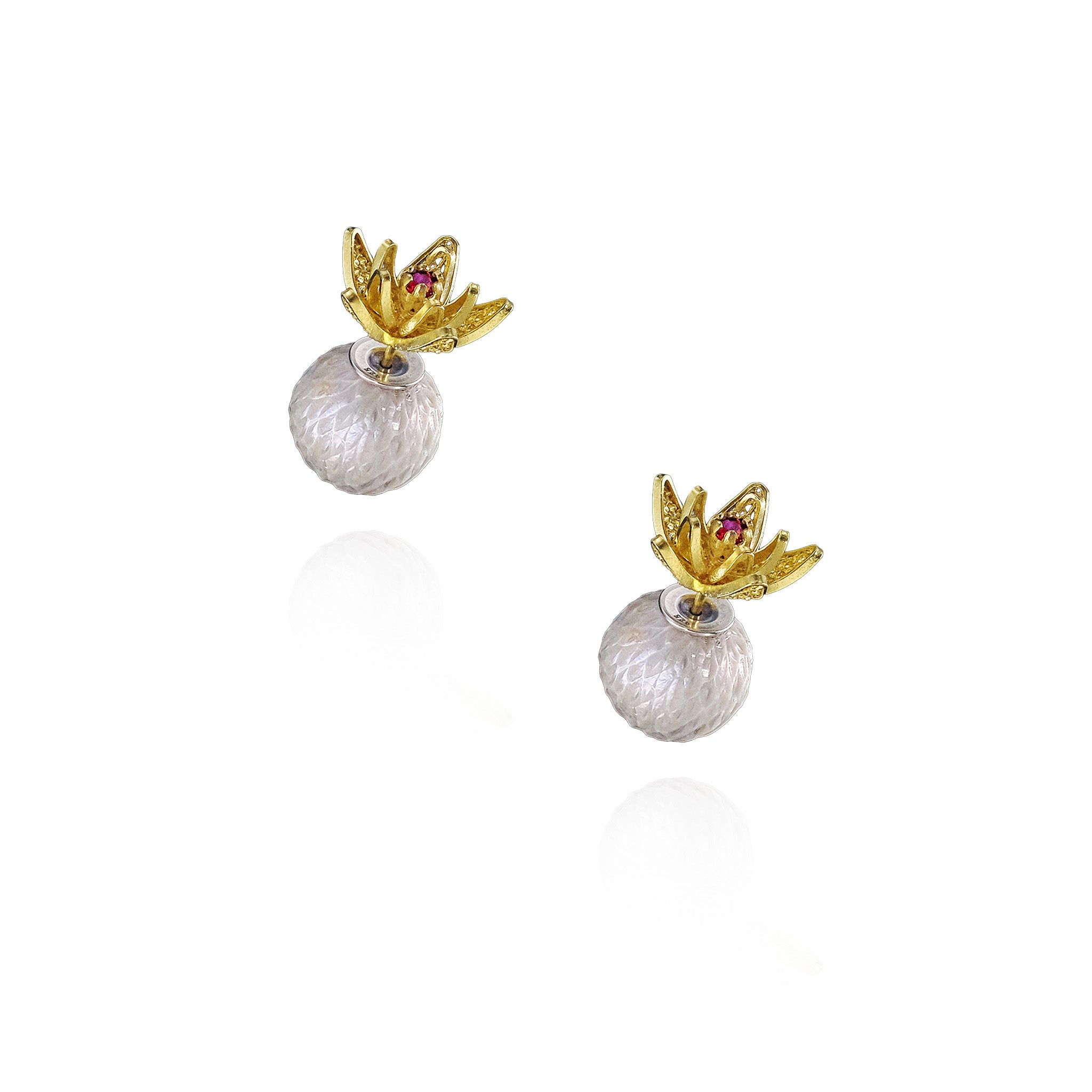 Pair of earrings with gold crowns and clear spherical stones on a white background